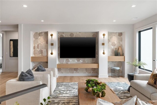 living room with a fireplace and light hardwood / wood-style flooring