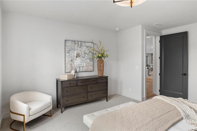 bedroom featuring visible vents, baseboards, and light colored carpet