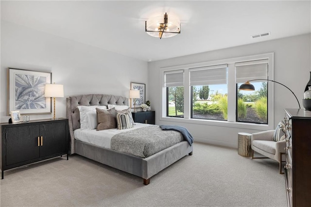 carpeted bedroom featuring a chandelier