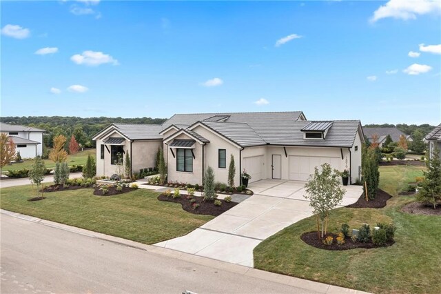 view of front of home with a front yard and a garage