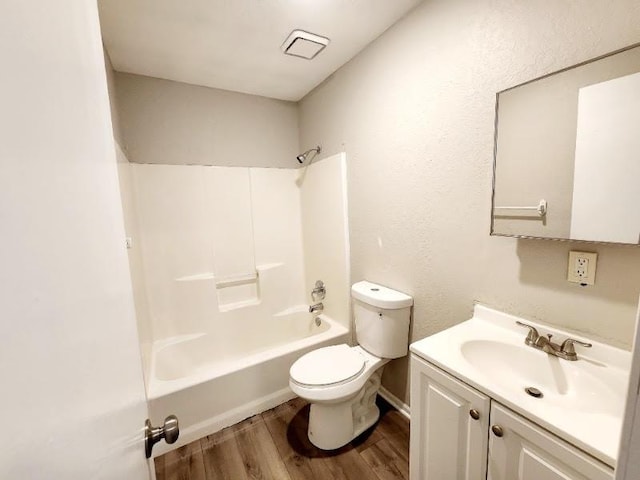 full bathroom with  shower combination, vanity, toilet, and hardwood / wood-style flooring