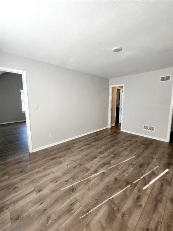 unfurnished room featuring dark hardwood / wood-style floors