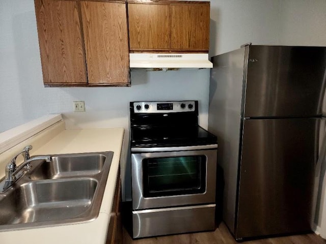 kitchen featuring sink, stainless steel appliances, and dark hardwood / wood-style flooring