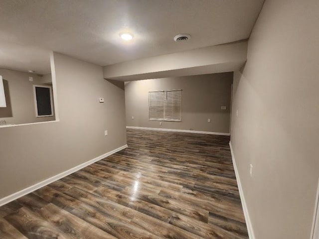 spare room with dark wood-type flooring