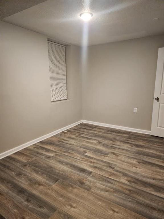 spare room with dark hardwood / wood-style floors