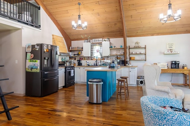 kitchen with stainless steel fridge with ice dispenser, black range oven, a chandelier, and white cabinets