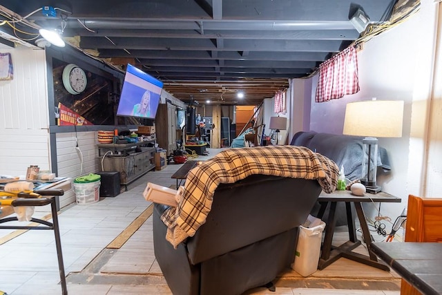 basement featuring wooden walls