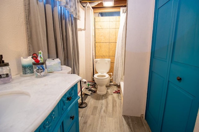 bathroom with a shower with curtain, vanity, toilet, and wood-type flooring