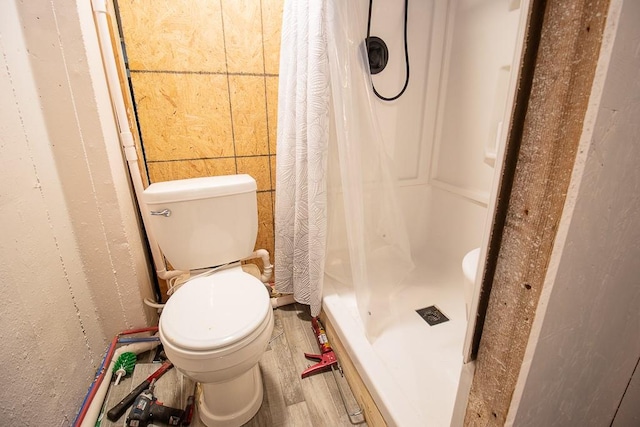 bathroom with a shower with curtain and toilet