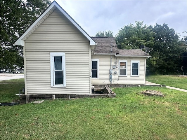 rear view of property with a lawn