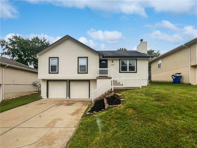 view of front of property with a front lawn and a garage