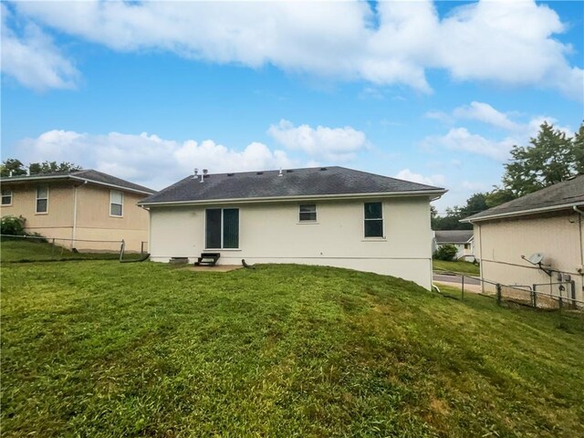 rear view of house with a lawn