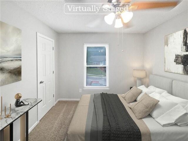 carpeted bedroom featuring a textured ceiling and ceiling fan