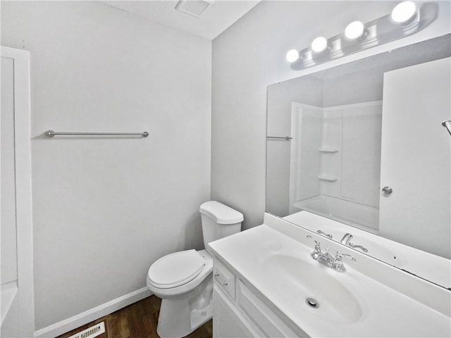 bathroom with hardwood / wood-style flooring, vanity, and toilet