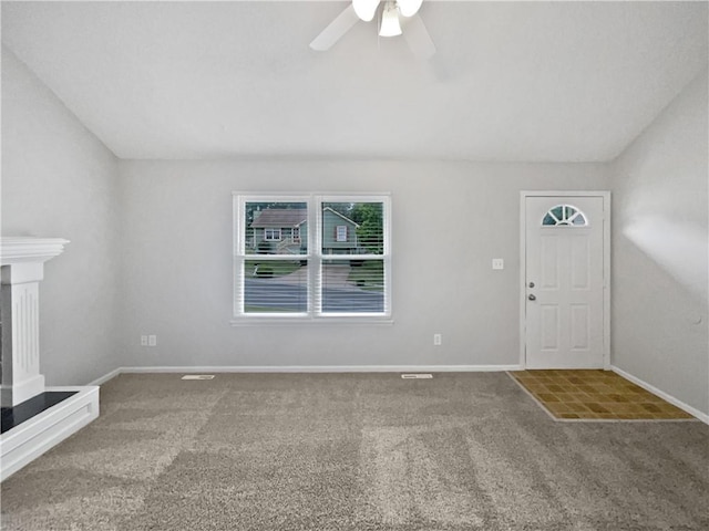 unfurnished living room featuring ceiling fan and carpet