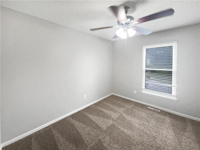 carpeted empty room featuring a textured ceiling and ceiling fan