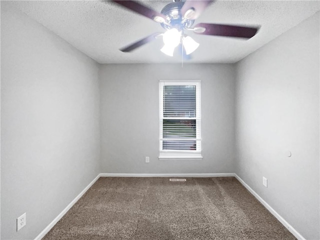 carpeted empty room featuring a textured ceiling and ceiling fan