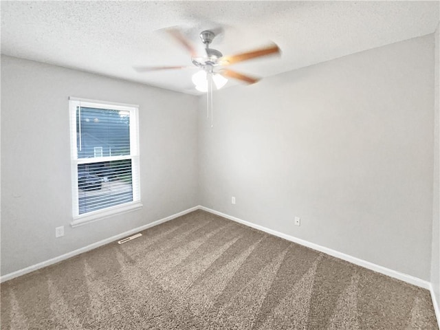 carpeted empty room with a textured ceiling and ceiling fan