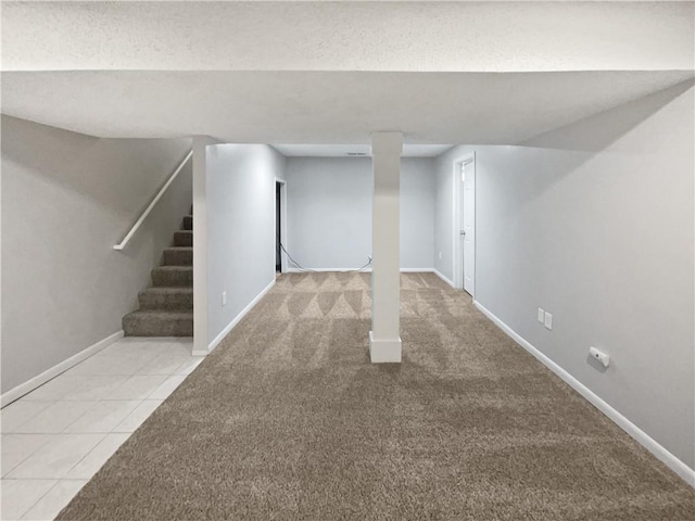 basement with a textured ceiling and light colored carpet