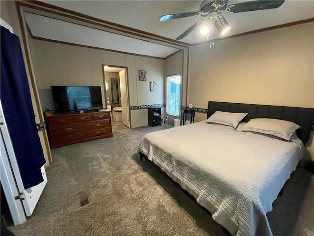 bedroom with lofted ceiling, ceiling fan, crown molding, connected bathroom, and carpet