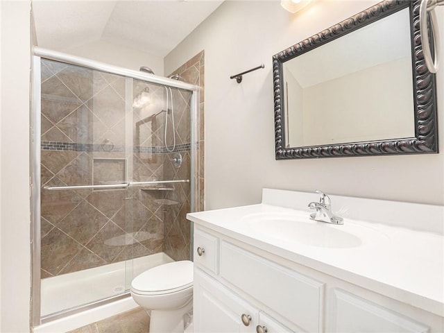 full bath featuring toilet, a stall shower, lofted ceiling, and vanity