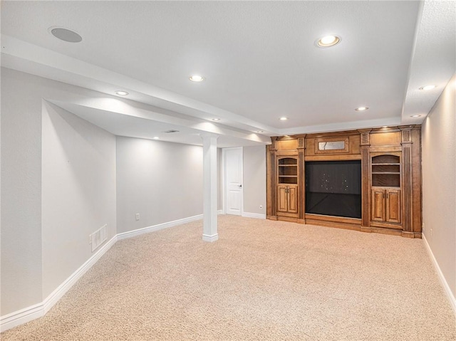 finished below grade area with baseboards, visible vents, carpet flooring, and recessed lighting