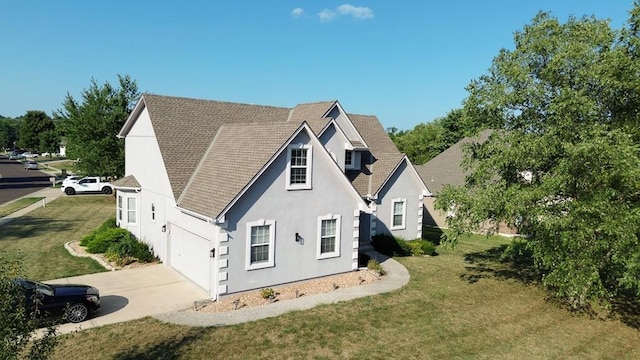 view of side of home featuring a garage, concrete driveway, a yard, and stucco siding