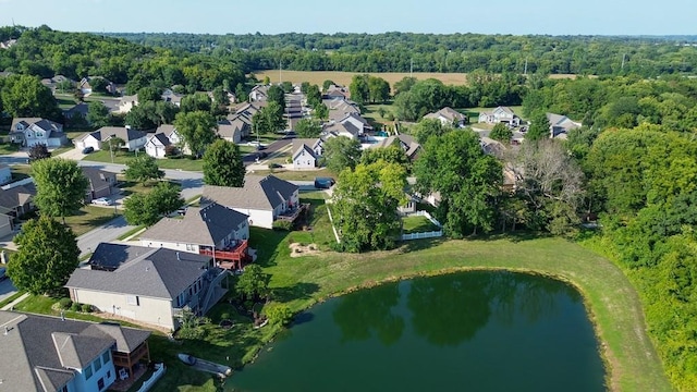 bird's eye view featuring a residential view, a water view, and a view of trees