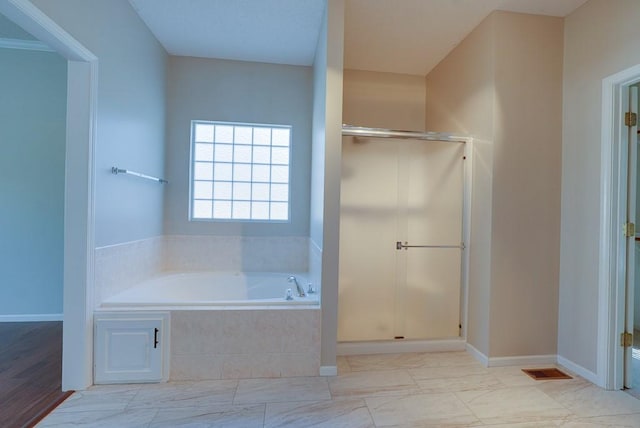 full bath featuring visible vents, a stall shower, a bath, and baseboards