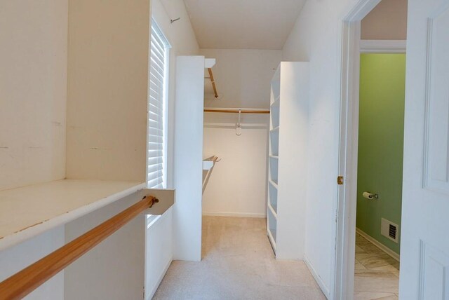 walk in closet with light carpet and visible vents