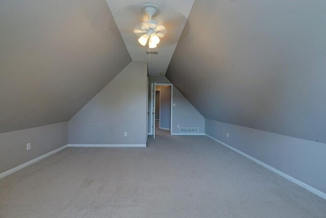 bonus room with lofted ceiling, visible vents, and baseboards