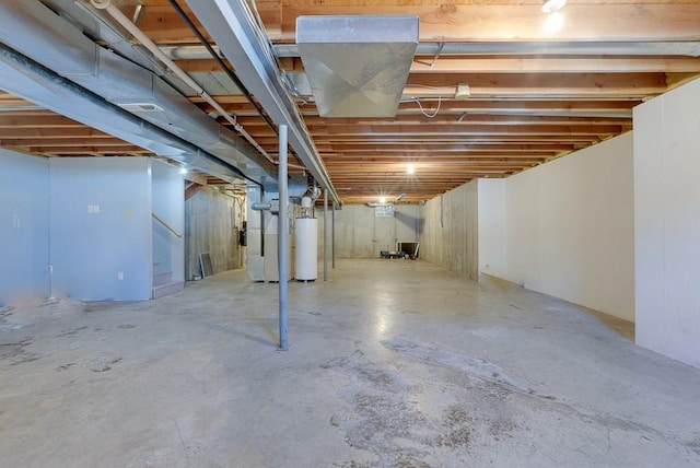 unfinished basement featuring heating unit, gas water heater, and stairway