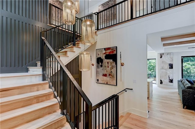 2207 W 71st St, Prairie Village, KS 66208 - staircase with wood finished floors, a chandelier, baseboards, and a high ceiling