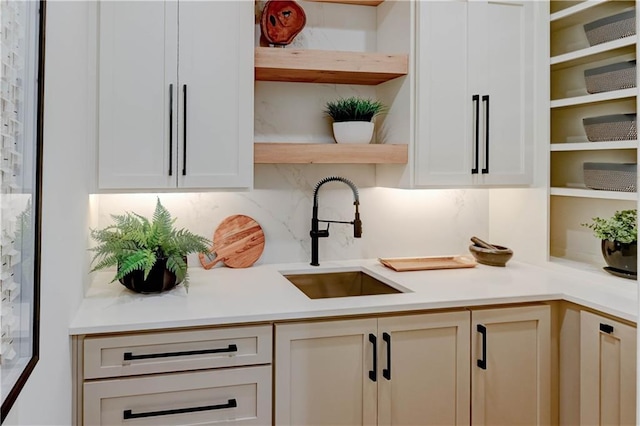 2207 W 71st St, Prairie Village, KS 66208 - kitchen featuring open shelves, a sink, backsplash, light countertops, and white cabinetry