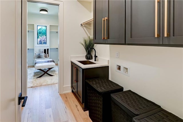 2207 W 71st St, Prairie Village, KS 66208 - washroom with cabinet space, light wood finished floors, and washer hookup