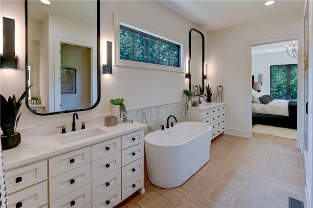 2207 W 71st St, Prairie Village, KS 66208 - ensuite bathroom featuring vanity, recessed lighting, and a freestanding bath