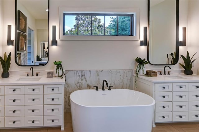 2207 W 71st St, Prairie Village, KS 66208 - bathroom with two vanities, a soaking tub, and tile walls