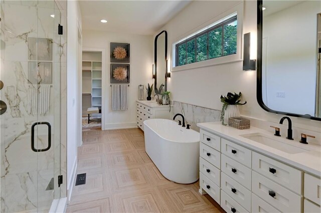 2207 W 71st St, Prairie Village, KS 66208 - bathroom featuring a marble finish shower, vanity, a freestanding tub, and recessed lighting