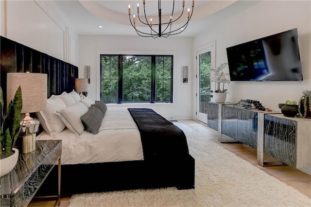 2207 W 71st St, Prairie Village, KS 66208 - bedroom with access to exterior, a chandelier, multiple windows, wood finished floors, and recessed lighting