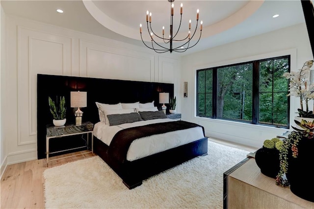 2207 W 71st St, Prairie Village, KS 66208 - bedroom with a chandelier, wood finished floors, a raised ceiling, and recessed lighting