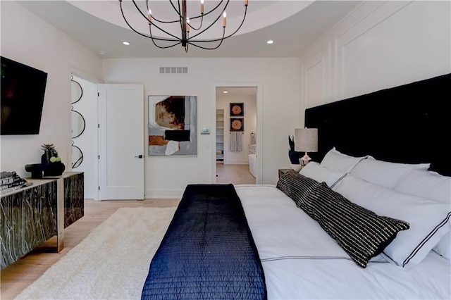 2207 W 71st St, Prairie Village, KS 66208 - bedroom featuring a chandelier, light wood-style floors, recessed lighting, ensuite bath, and baseboards