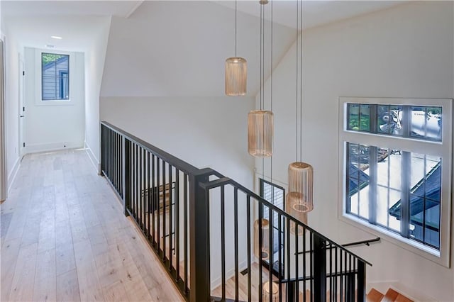 2207 W 71st St, Prairie Village, KS 66208 - hallway with an upstairs landing, wood finished floors, and lofted ceiling