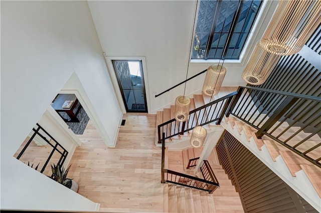 2207 W 71st St, Prairie Village, KS 66208 - stairs with wood finished floors, baseboards, and a towering ceiling