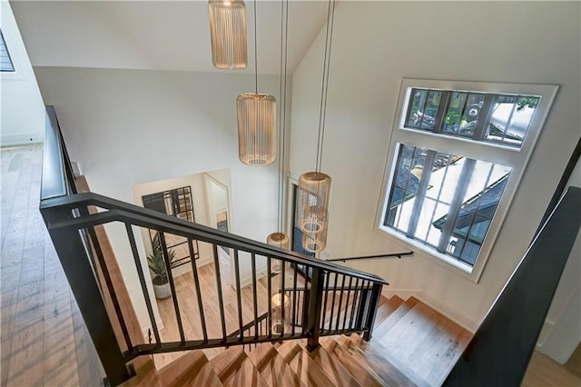 2207 W 71st St, Prairie Village, KS 66208 - stairway with wood finished floors, baseboards, and high vaulted ceiling