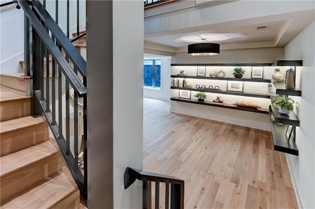 2207 W 71st St, Prairie Village, KS 66208 - stairway featuring wood finished floors and a tray ceiling
