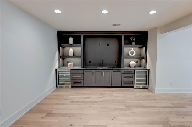 2207 W 71st St, Prairie Village, KS 66208 - indoor wet bar with beverage cooler, light wood-style flooring, baseboards, recessed lighting, and built in features