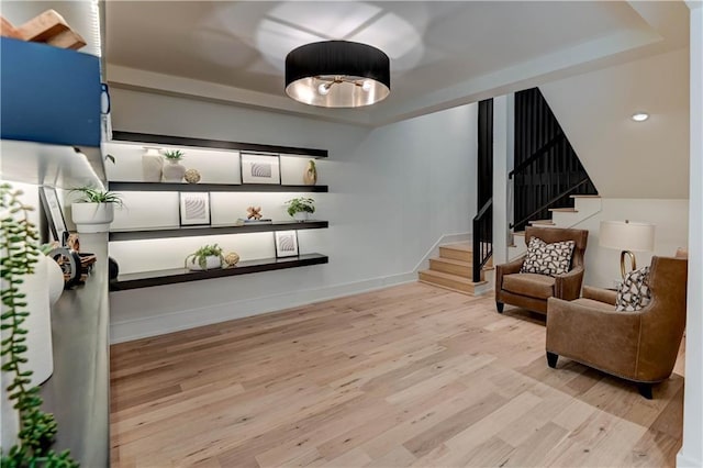 2207 W 71st St, Prairie Village, KS 66208 - sitting room featuring stairs, wood finished floors, a raised ceiling, baseboards, and recessed lighting