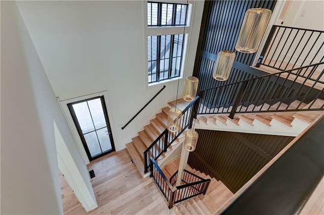2207 W 71st St, Prairie Village, KS 66208 - stairs featuring a towering ceiling, healthy amount of natural light, and wood finished floors
