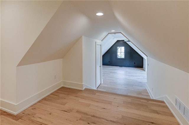 2207 W 71st St, Prairie Village, KS 66208 - additional living space with vaulted ceiling, wood finished floors, baseboards, and recessed lighting