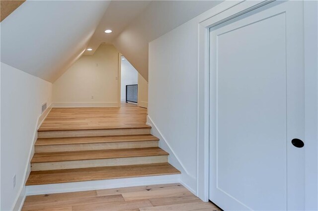 2207 W 71st St, Prairie Village, KS 66208 - staircase featuring recessed lighting, vaulted ceiling, wood finished floors, and baseboards